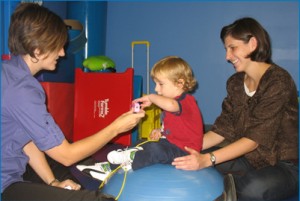 Speech Therapist and Parent Playing with Child