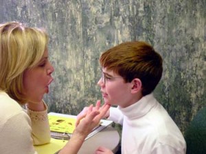 Speech Therapist Checking Child's Mouth