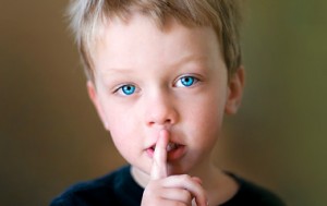 Child with Finger Over Lips