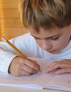 Child Writing with Pencil