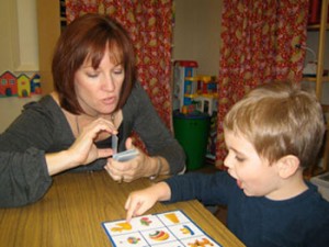Speech Therapist Working with Child on Vocabulary