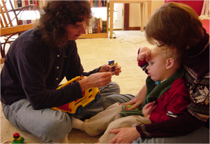 Speech Therapist Working with Child with Tracheostomy