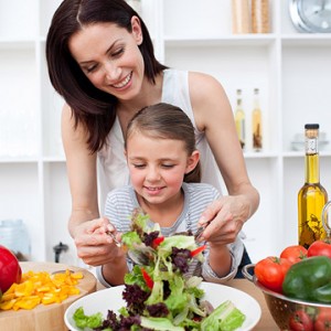Parent Teaching Child How to Make Salad