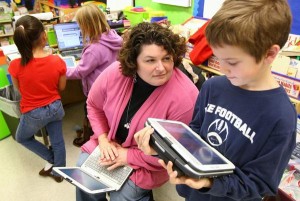 Child Working with Apps in Classroom