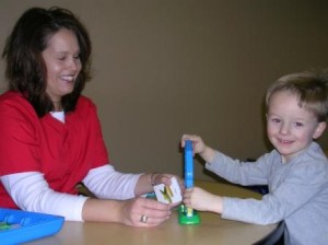 Speech Therapist Working with Child on Articulation