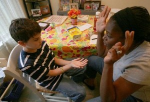 Speech Therapist Working with Autistic Child