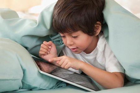 Child Using App Under Blanket