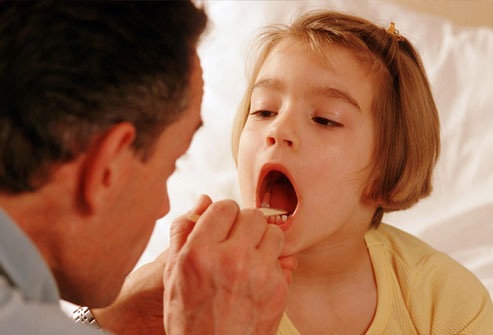 Doctor Examining Child's Throat