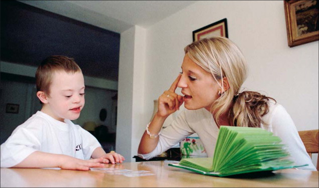 Boy with Down Sydrome in Speech Therapy 