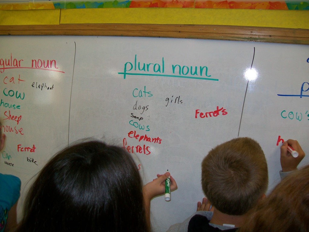  children writing plural nouns