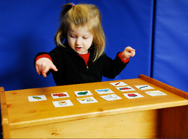 girl using symbol cards in therapy